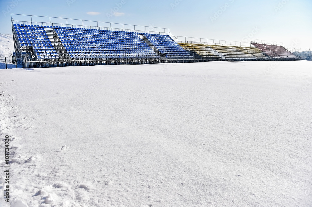 Fototapeta premium Empty tribunes on a stadium after heavy snowfall