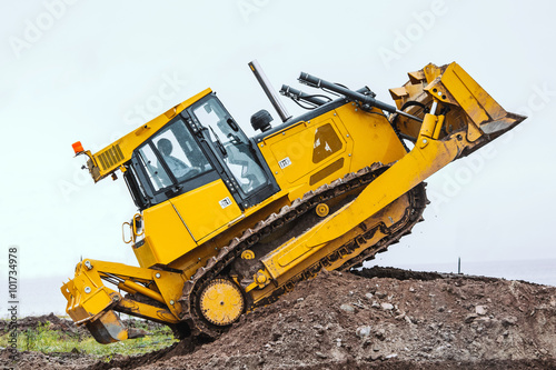 Yellow bulldozer overcome barrier