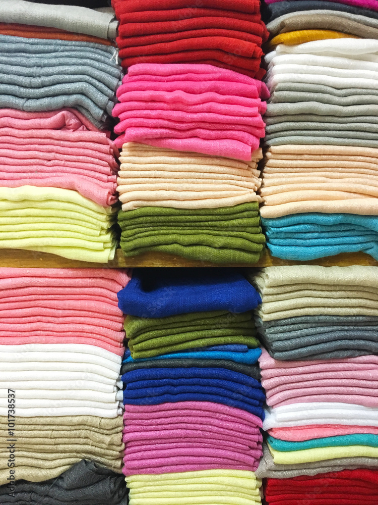 stacked colorful fabrics in the shop.