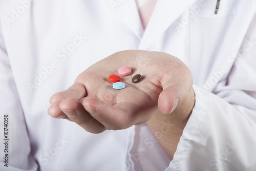 Closeup of a hand holding some colored pills