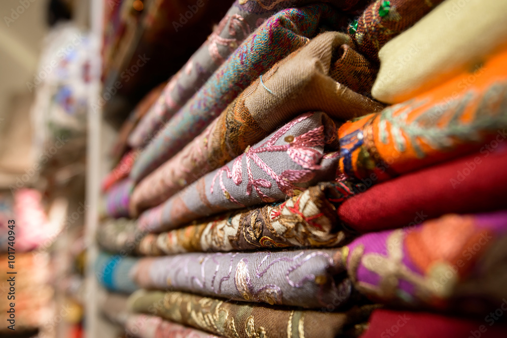 Colourful silk scarfs hanging at a market stall