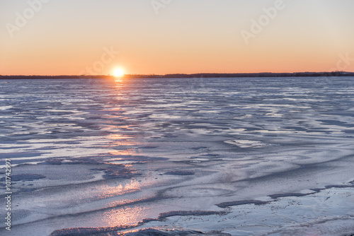 Sunset over a frozen Lake Butte des Morts.  Photographed from the dock at the boat launch in the Town of Butte des Morts.