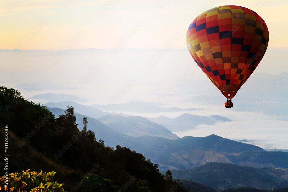 Hot air balloon over mountain in sunrise. Travel concept.