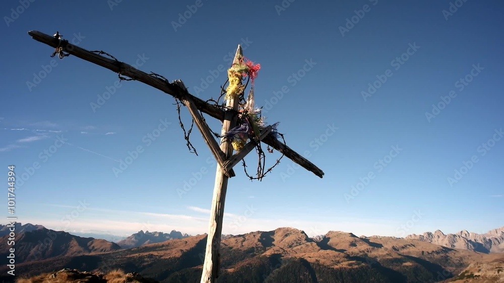 Cross with flags on top of the mountain