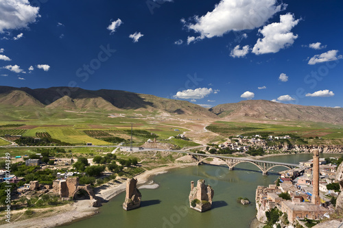 Turkey. Hasankeyf village (Southeastern Anatolia). Aerial view from the Fortress on the Tigris River with remains of the Old Bridge (broken arches and pylons) photo