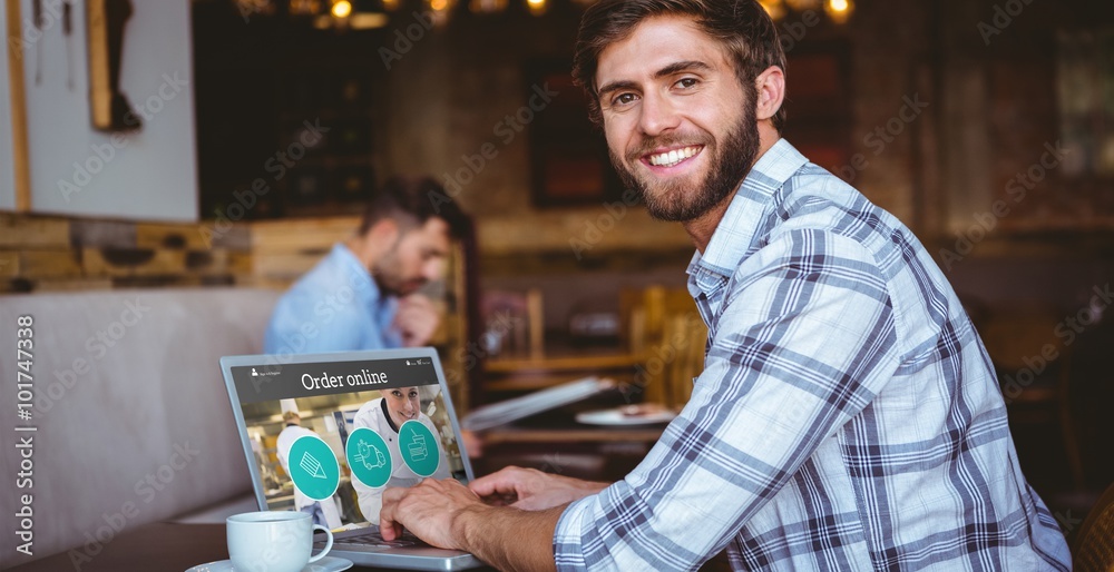 Fotografie Composite image of young man working on his computer