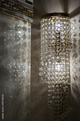 Brass sconces with crystal. Lighted sconces with crystal pendants. 
