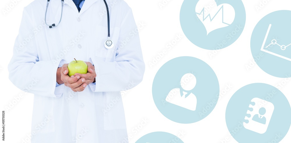 Obraz premium Composite image of male doctor holding green apple