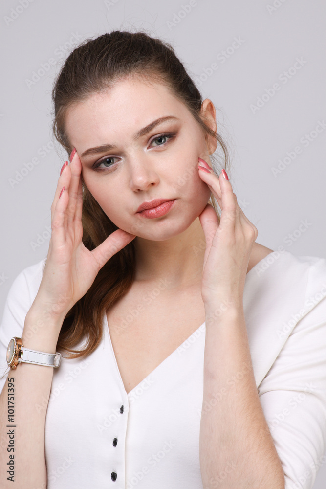 Beautiful young woman with headache touching her temples Beautiful young woman with headache touching her temples