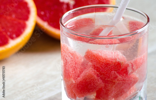 A glass of refreshing drink with grapefruit and grapefruit