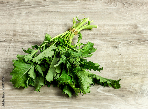 broccoli rabe over wooden surface