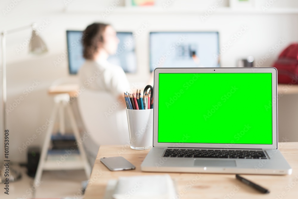 Green screen laptop computer and a glass with color pencils on wooden table, creative office on the background Green screen laptop computer and a glass with color pencils on wooden table, creative office on the background