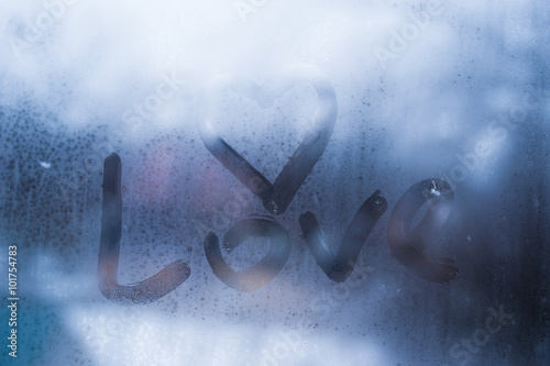 Autumn rain, the inscription on the sweaty glass - love and heart photo