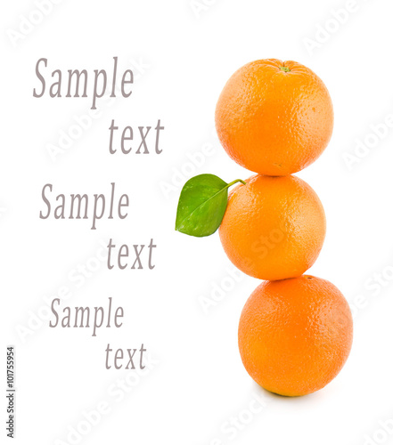 three oranges stand on each other on a white background