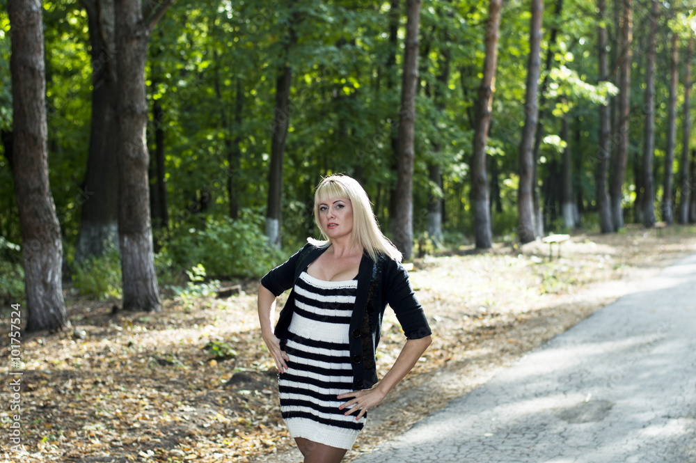 the beautiful woman the blonde walks in park the beautiful woman the blonde walks in park