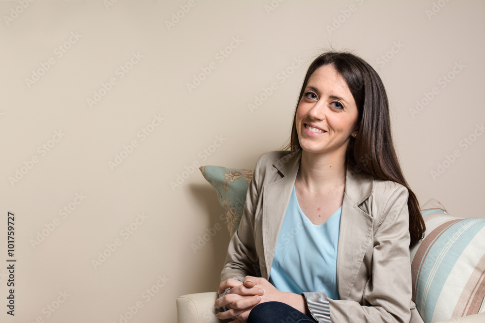 Black businesswoman sitting, looking at camera and smiling Black businesswoman sitting, looking at camera and smiling