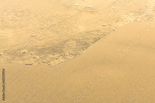 Sand beach with the soft wave.