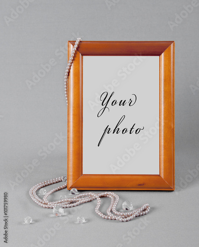 beads hang on a frame for a photo on grey fabric photo