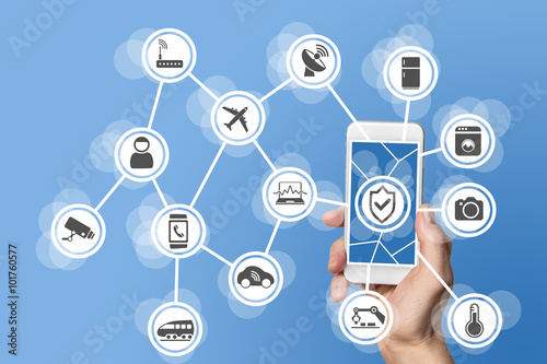 Internet of things security concept illustrated by hand holding modern smart phone with connected sensors in objects.