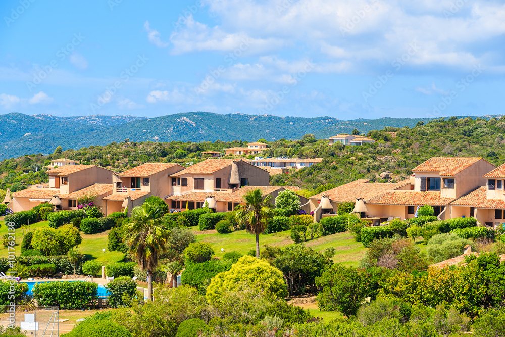 Typical Corsican villa houses on green hill in rural landscape of Corsica island, France