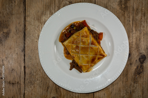 Confit duck pie, from above. Modern take on a traditional French dish with puff pastry
