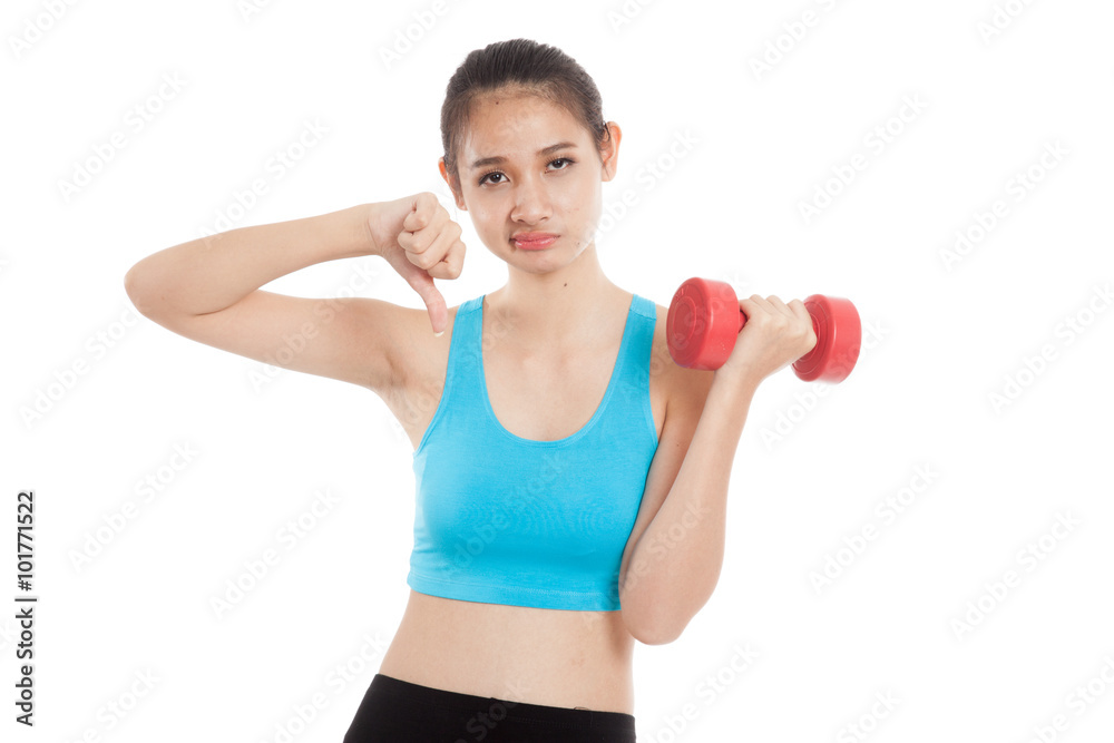 Beautiful Asian healthy girl thumbs down with dumbbell Beautiful Asian healthy girl thumbs down with dumbbell