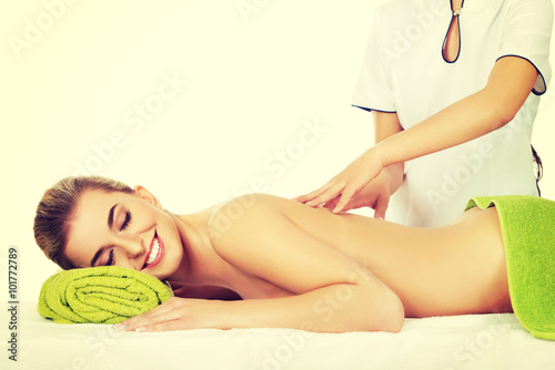 Young smile woman lying on a massage table and has massage.
