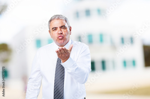 mature man sending a kiss