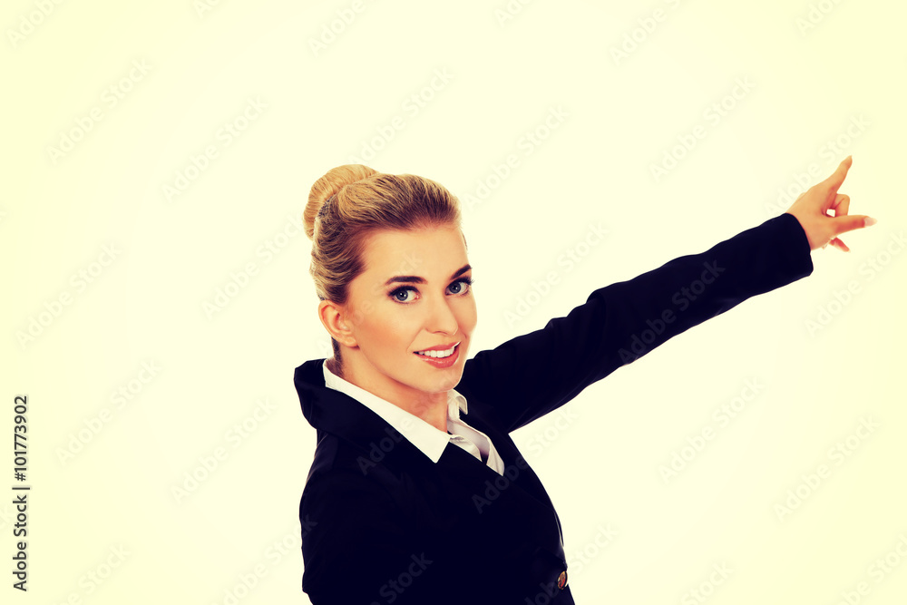Young businesswoman pointing at something Young businesswoman pointing at something