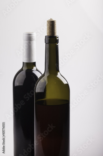 two bottles of wine on white background closeup