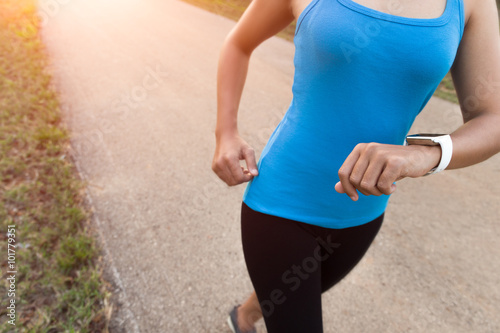 closeup woman running on rural road during sunset