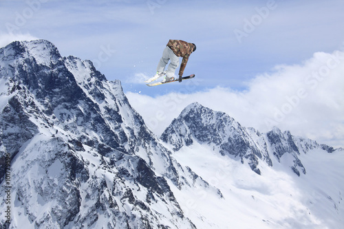 Flying skier on mountains. Extreme ski sport.