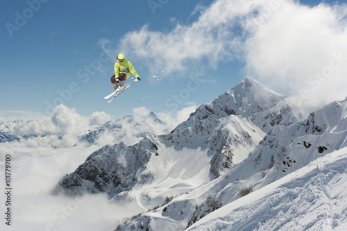 Flying skier on mountains. Extreme ski sport.