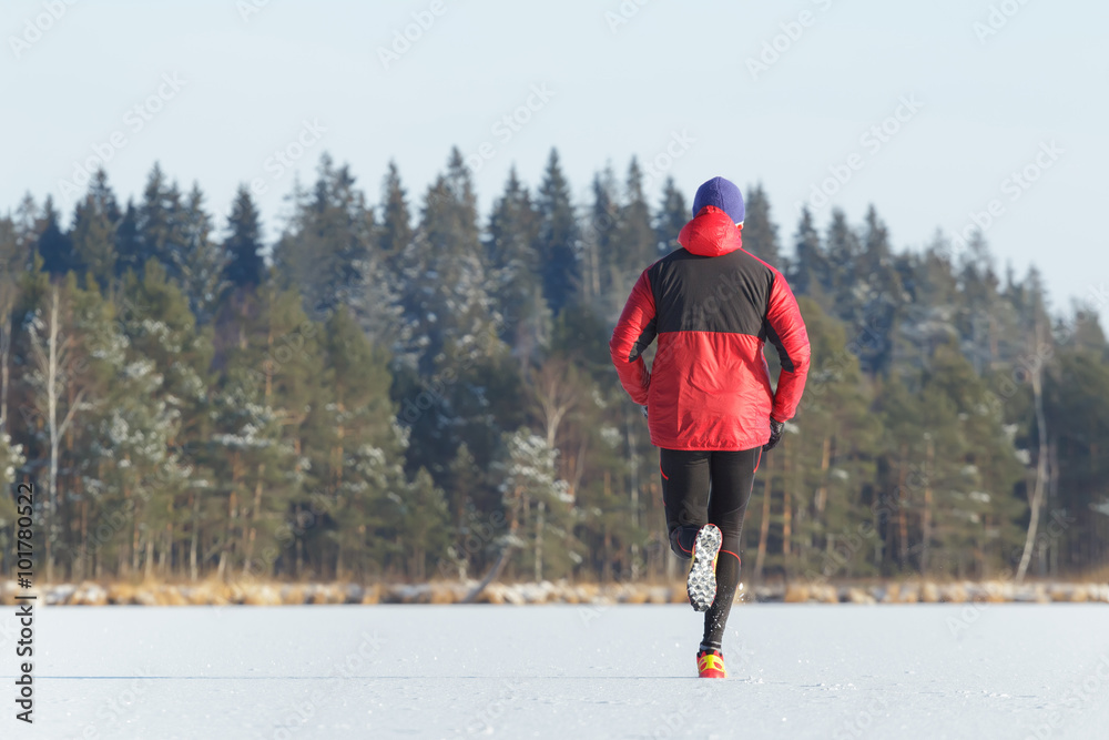 Sportsman taking part in trail running race outdoor in winter