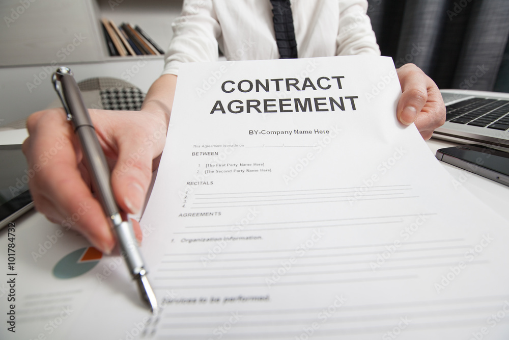 Business woman signing the contract document Business woman signing the contract document