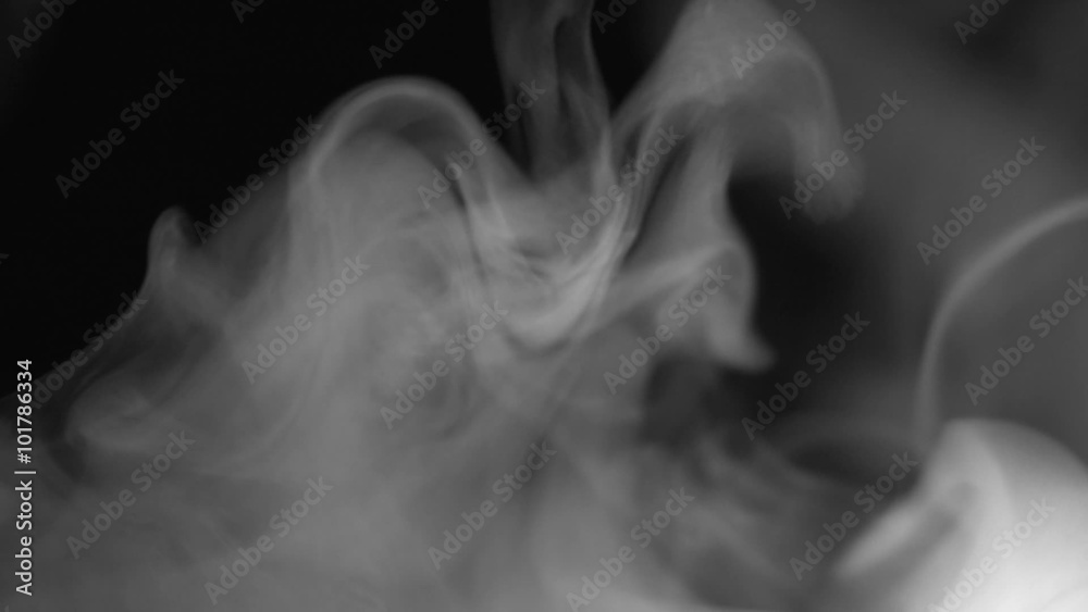 Real white steam looking like smoke isolated on black background. Clouds of white fantasy smoke abstract magic mystic fog toxic gas fumes pollution. Slow motion. Camera locked down. Recorded in 60fps