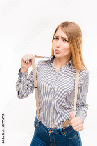 Photography Portarit of happy young girl with suspenders pouting her lips