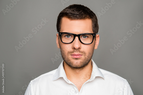 Portrait of serious smart man in glasses