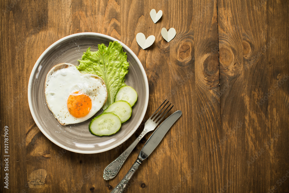 Romantic breakfast with scrambled eggs in a heart-shaped Valentine's Day Romantic breakfast with scrambled eggs in a heart-shaped Valentine's Day