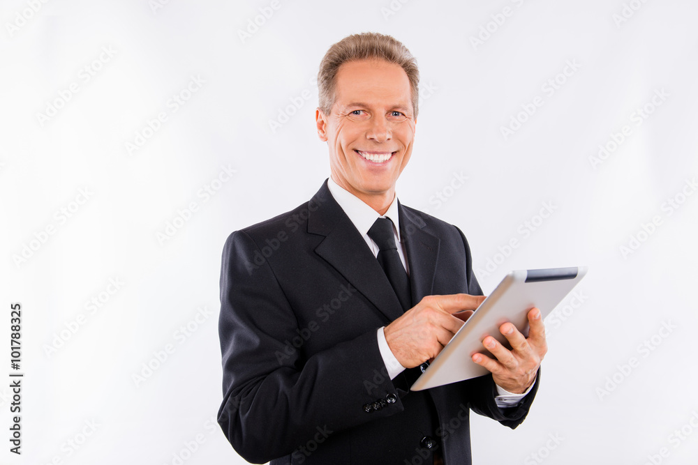 A successful mature manager with ebook in his hands A successful mature manager with ebook in his hands
