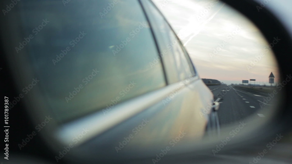 View of the highway with the side mirror of a vehicle View of the highway with the side mirror of a vehicle