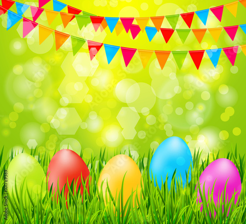 Easter background with colorful eggs in green grass and flags