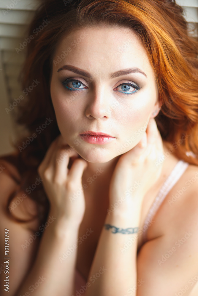 Closeup portrait of redhead young woman with curls and perfect makeup Closeup portrait of redhead young woman with curls and perfect makeup