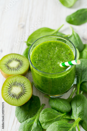 fresh green smoothie on wooden surface