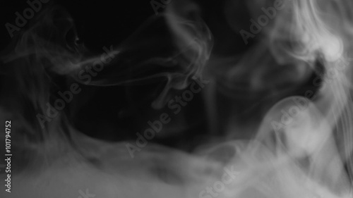 Real white steam looking like smoke isolated on black background. Clouds of white fantasy smoke abstract magic mystic fog toxic gas fumes pollution. Slow motion. Camera locked down. Recorded in 60fps