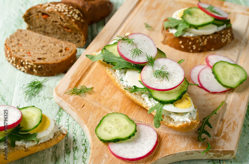 Sandwiches with egg, radish, cucumber and arugula