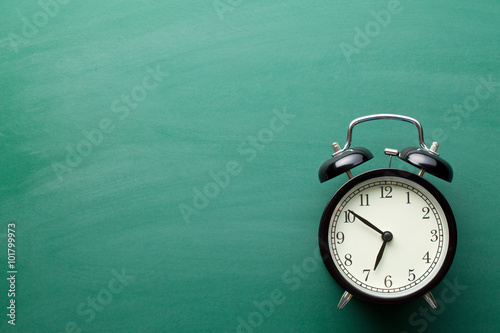 alarm clock on chalkboard