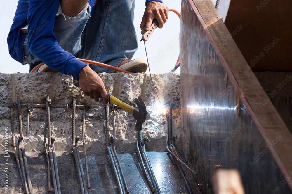 Fototapeta premium worker welding steel metal