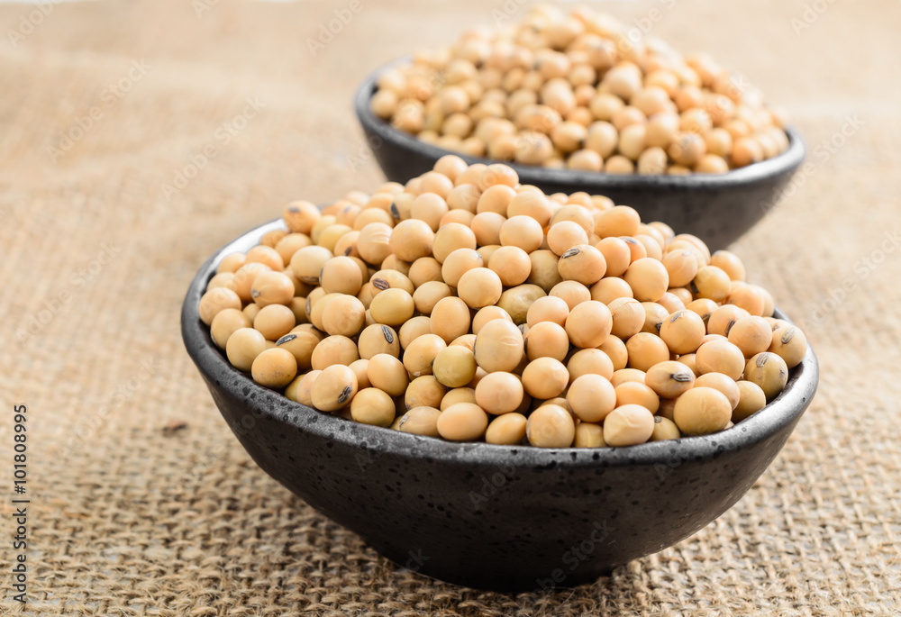 soybeans in ceramic bowl on sackcloth background.. soybeans in ceramic bowl on sackcloth background..