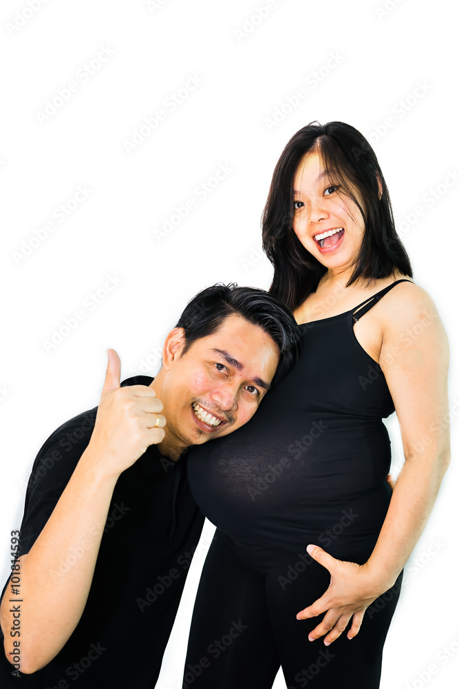 husband smiling and showing his thumbs up while listening to his pregnant wife belly husband smiling and showing his thumbs up while listening to his pregnant wife belly